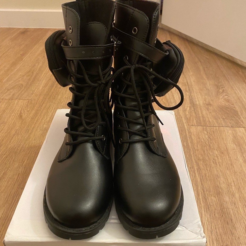 Black combat boots with small side pocket